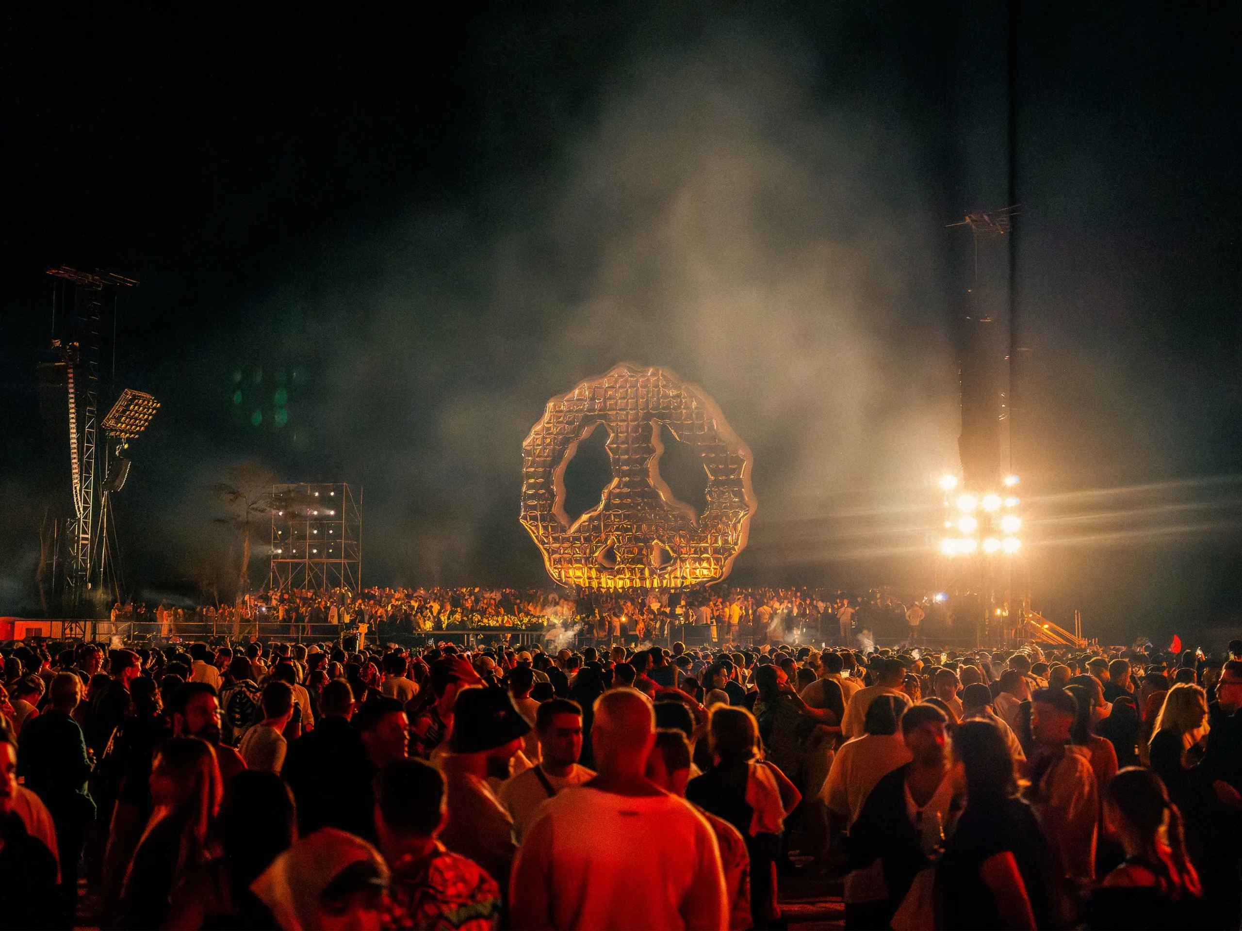 A night crowd under the stage lights at a jungle festival in Tulum